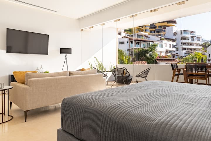 Floor to ceiling glass patio doors to take in the views from the open concept living room and second bedroom.