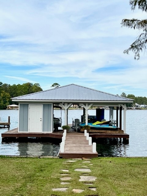 A charming dock is depicted on the water, featuring a covered seating area with chairs and lounge equipment. A wooden pathway leads from the grassy shore to the dock, complementing the serene lakeside environment.