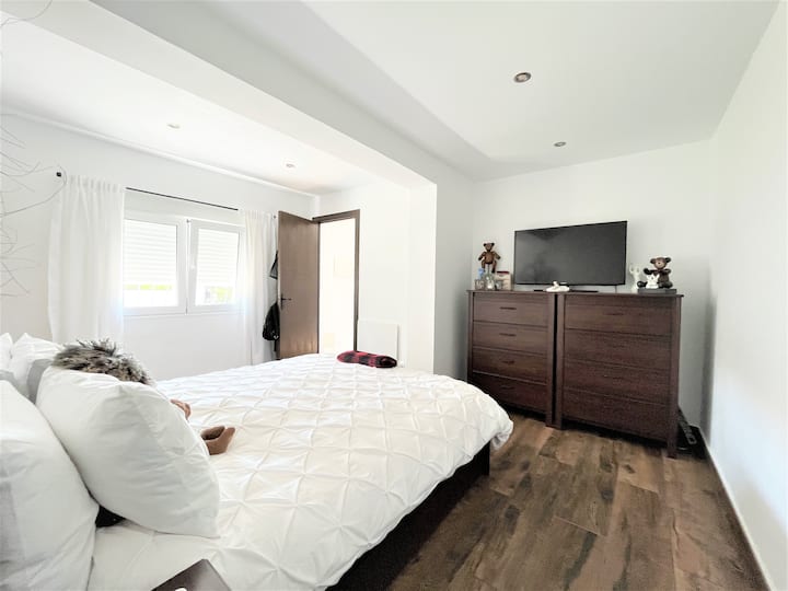 Bedroom #1: King-size bed, bathroom with a tube and a shower, and a dressing room