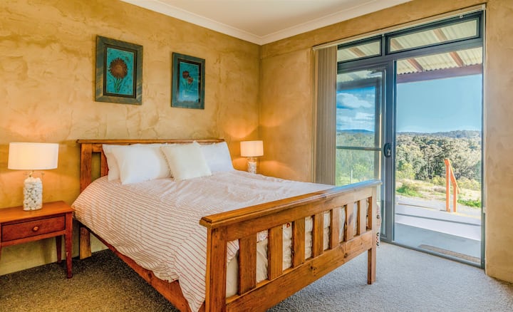 Main bedroom - queen bed, with access to verandah