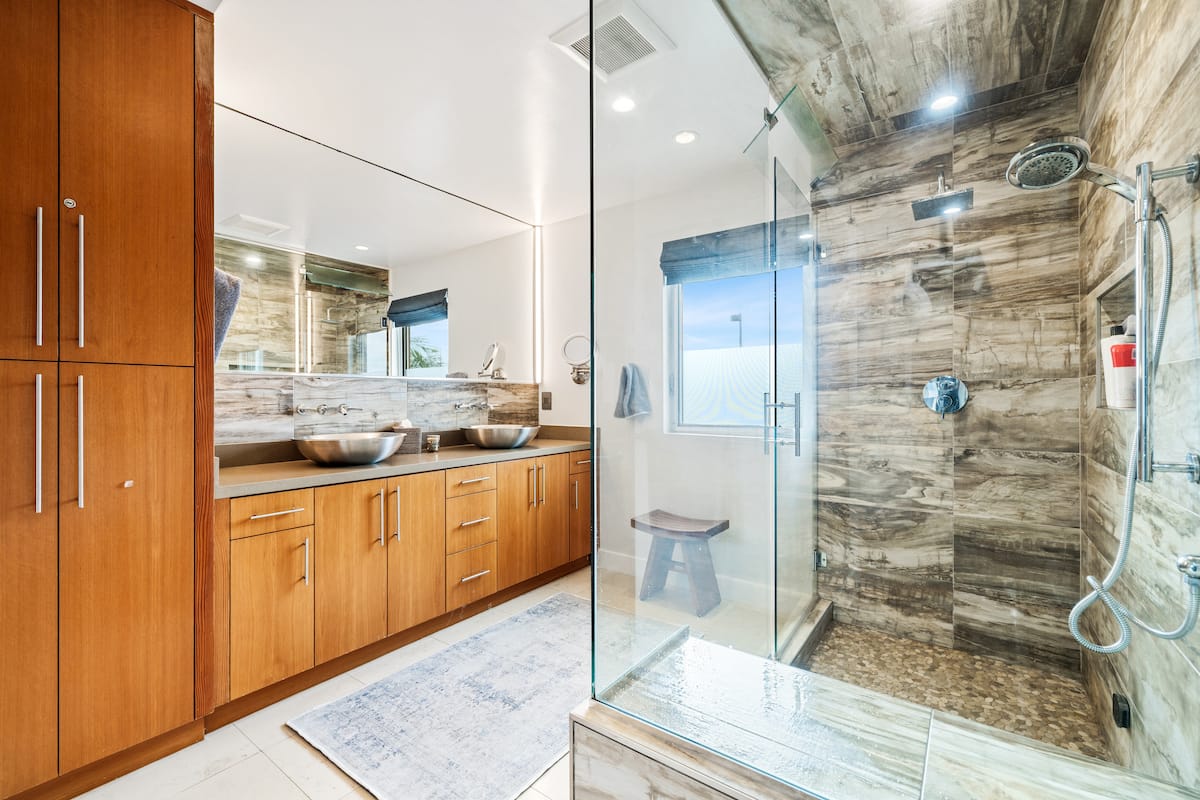 Bathroom with glass shower and wood vanity