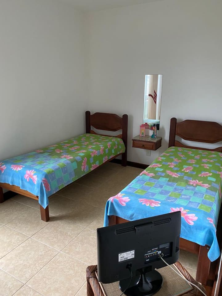 Втора спална соба со единечни кревети и плакар.