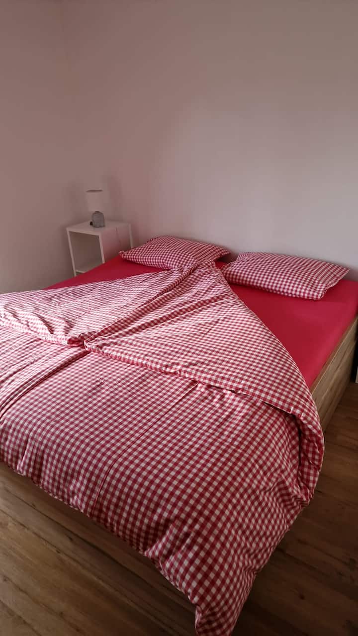 A bedroom with a double bed