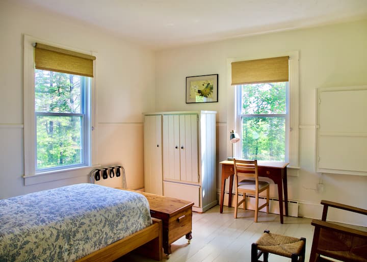 Downstairs bedroom with a dedicated workspace.