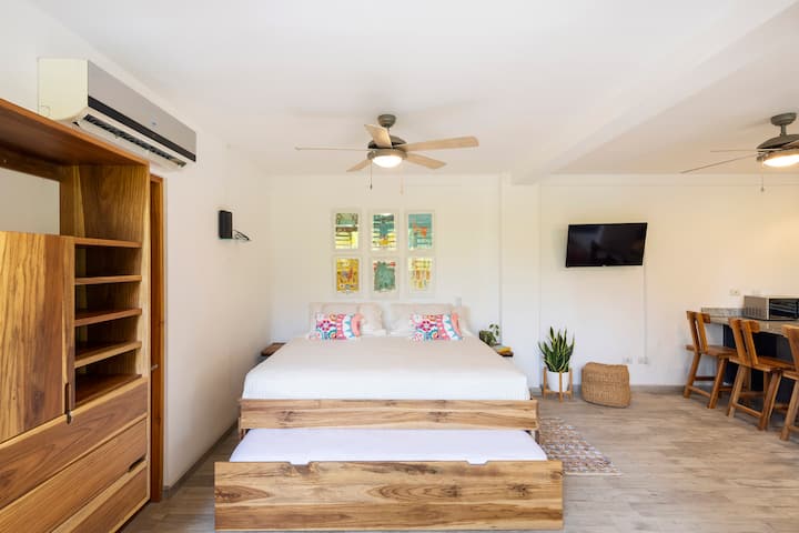 Bedroom area designed for restful sleep and total relaxation. Features a handcrafted solid teak wood king-size bed with a convenient pull-out full size trundle bed for additional sleeping up to 4. Enjoy split air conditioning and a ceiling fan.