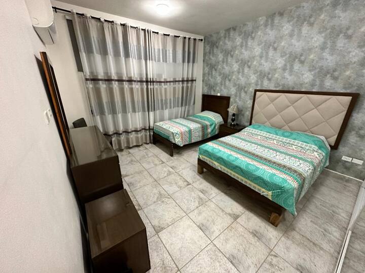 Second bedroom with double bed and single bed and mini split.