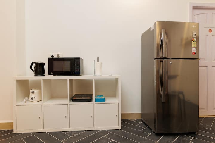the microwave, toaster, water kettle and induction stove with a refrigerator.