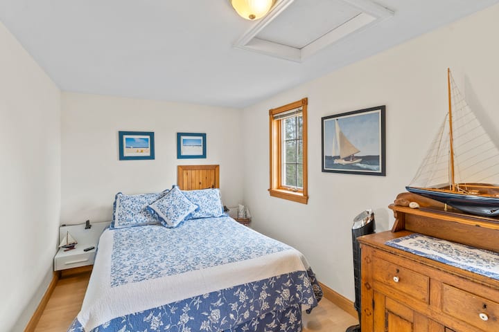 On the second floor, you'll find The Sailboat Room with a full closet, dresser, a queen bed & a laundry closet with a dryer, iron and ironing board.