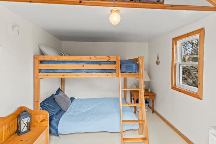 Anne's Bunkie features a mini fridge for drinks, a bunkbed with two double mattresses and storage. A short walk to the main cottage and washroom.