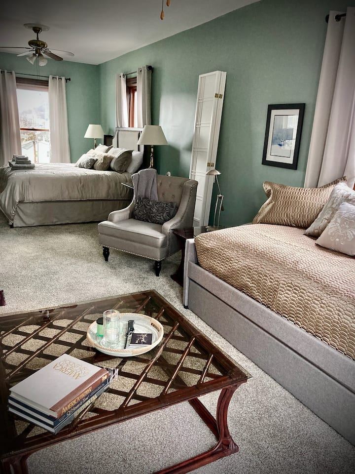 Upstairs suite - viewed from sitting area into king sleeping area. Trundle can sleep two with a twin mattress on top and on rollout. Screen dividers provided if you prefer privacy between the spaces.