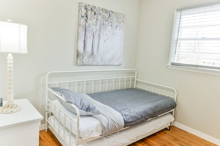 Third bedroom with a twin over twin trundle bed, chest and night stand plus a Smart Tv on top of the chest. 