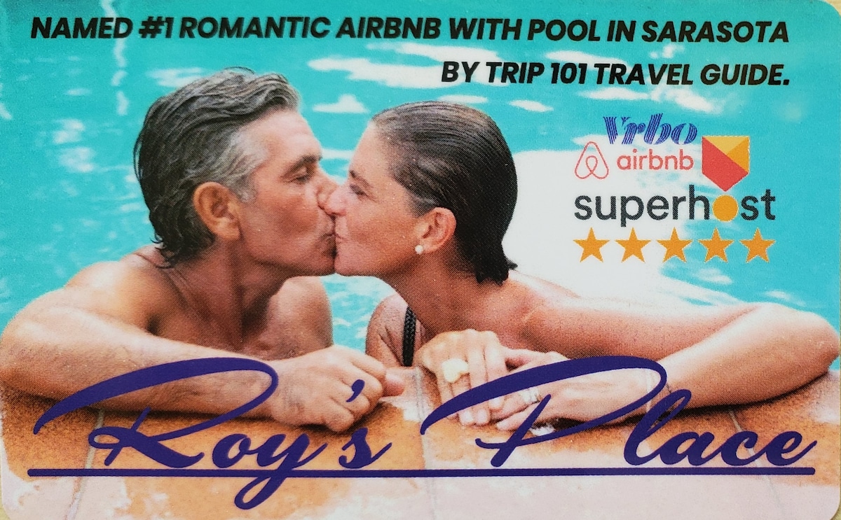 A couple is seen enjoying a moment by the pool, with the warm water shimmering under sunlight. The surrounding area features lush tropical landscaping, enhancing the private and serene setting of the accommodation.
