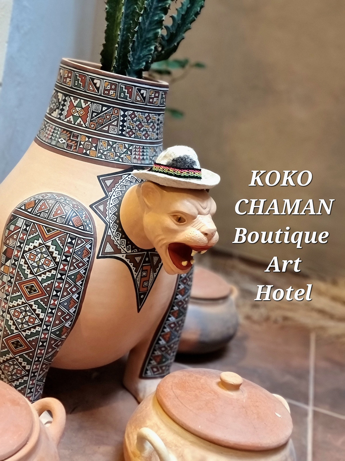 A handcrafted ceramic pot with intricate traditional designs is showcased in the image. A small decorative hat sits atop a playful animal figure emerging from the pot. Two additional clay pots are placed beside it, contributing to the artistic atmosphere.