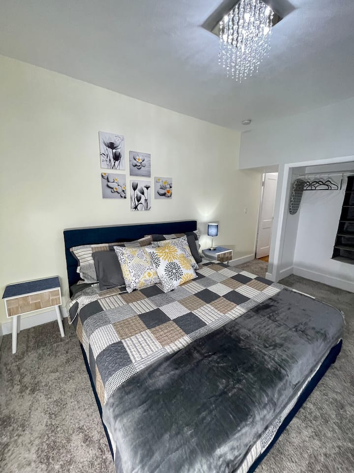 King Size Bed In Room With Carpeted Flooring