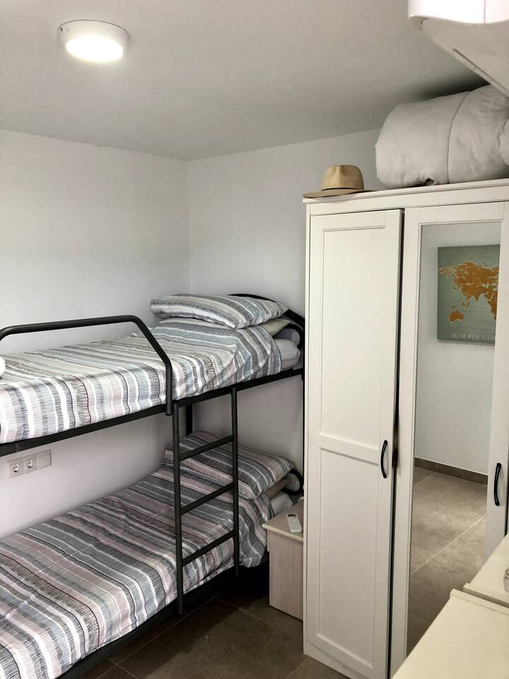 Bunk bedded room at the side of the villa with a window/door (not showing in the picture) which leads out to the uppermost terrace with the jacuzzi.  
Wash/shower room right next door.