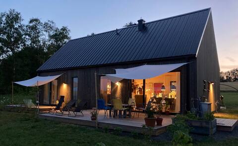 Seaside house with small pool in open landscape