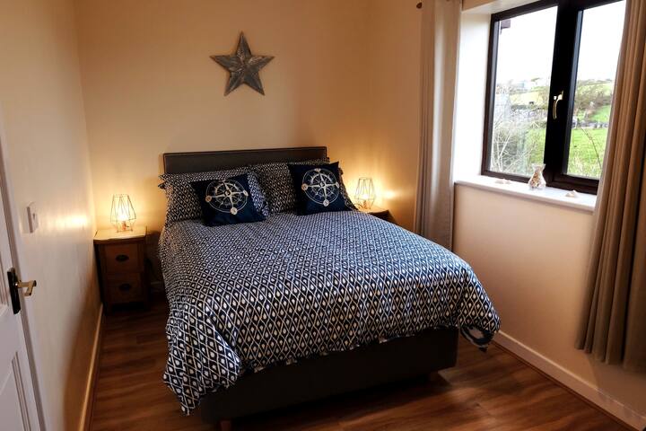 Bedroom 2- Double bed with countryside and sea views.