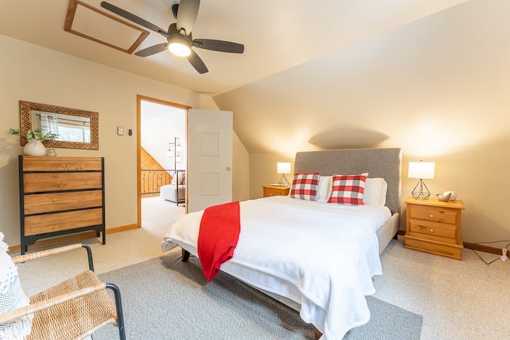 “Inviting bedroom with plush bedding and cozy cottage touches.”