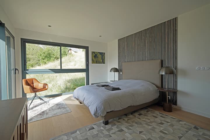 Bedroom 1 of Loft Takapuna with lake and mountain views. 