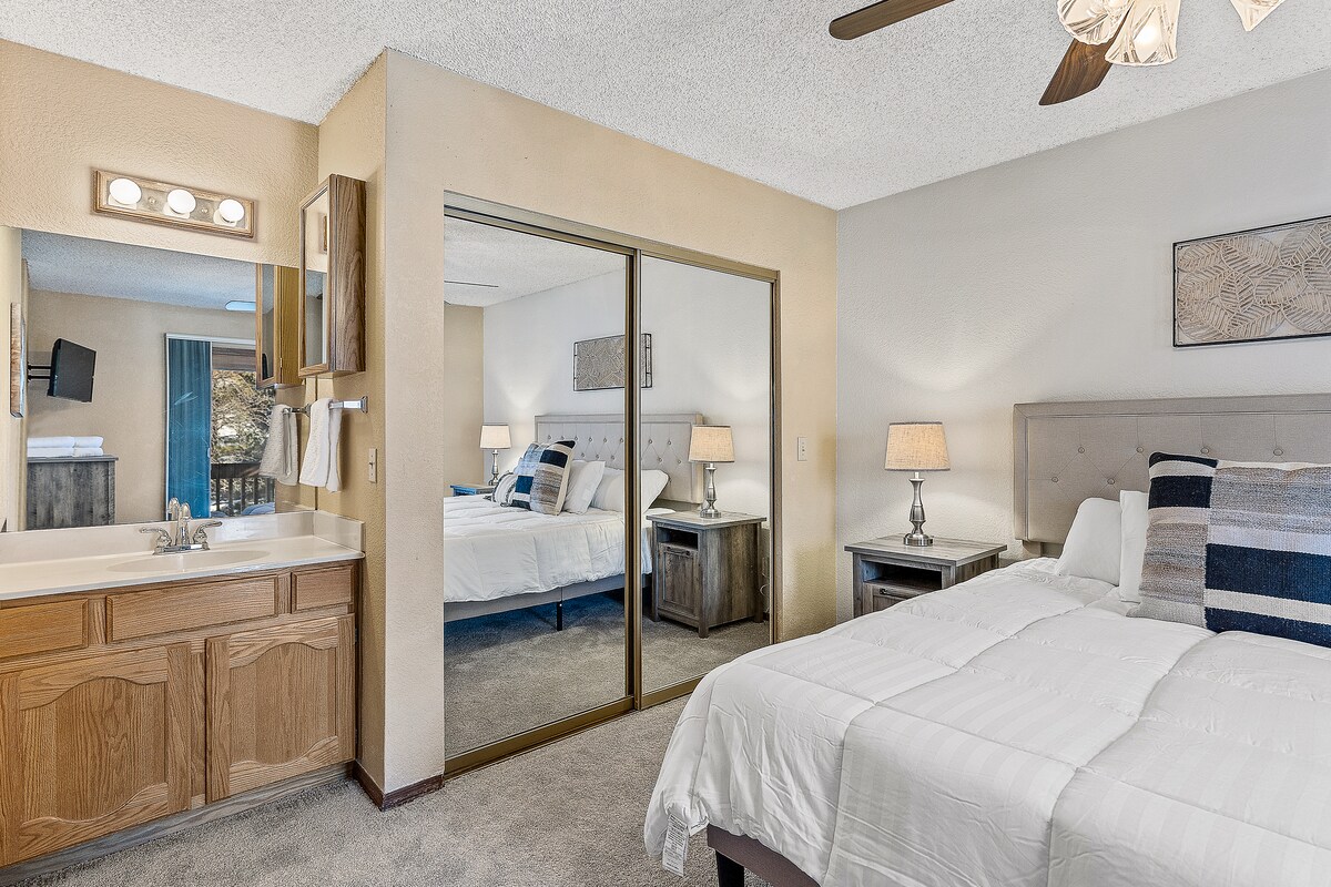Primary bedroom with king bed and built in sink and closet. 