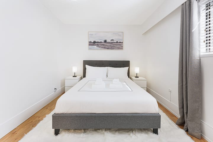 "Experience Comfort and Entertainment in Our Queen Bedroom with a 55-inch TV, Streaming Services, Beautiful Artwork, and Convenient Touch Lamps with USB Charging. Stay Organized with Our Luggage Rack and Relax in Style."
