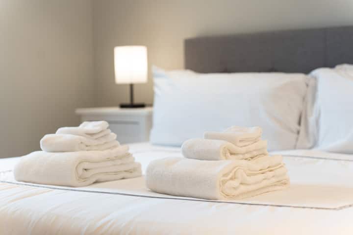 "Stay comfortable and refreshed with a set of towels for each guest in every room. Enjoy personalized details and comfortable furniture that make this space truly special. Come, unwind, and let us take care of the little things for you!"