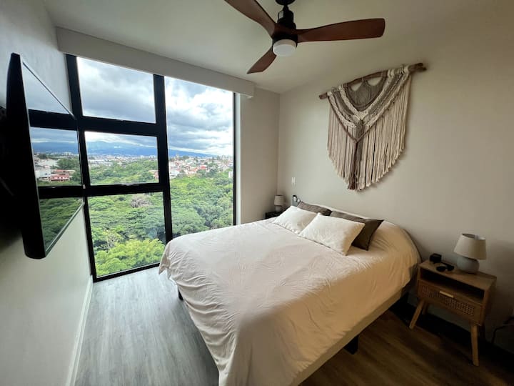 Main room with stunning view. Also full body mirror, closet, 55" TV, Google TV, Electric curtains, Noiseless ceiling fan, White noise machine. 
