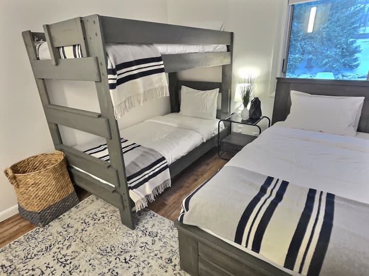 A charming bedroom featuring a single bed and bunk bed arrangement.