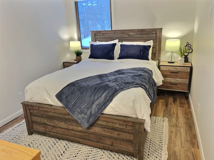 Unwind in a bedroom adorned with the rustic charm of a queen bed.
