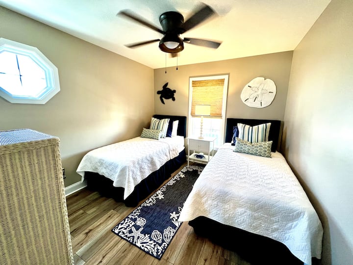 The third lower level bedroom offers two twin beds dressed with luxury linens, closet and smart tv.