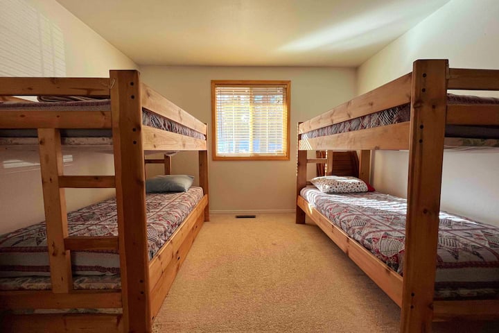 Guest bedroom with four twin bunk beds. Perfect for children or just extra room for a larger group.