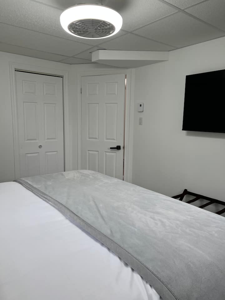 Bedroom #3 (basement) including:
king bed,
fan and adjustable light, 
Smart TV (Videotron), 
bedside tables with touch lamps, USB ports and electrical outlets,
digital alarm clock and 
luggage rack