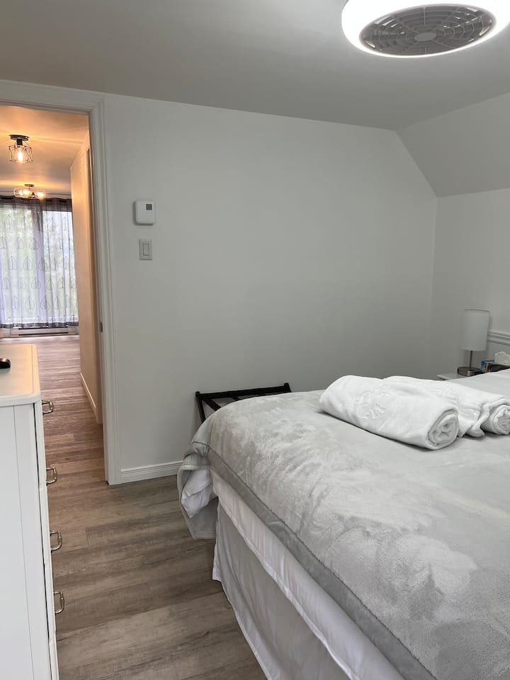 Bedroom #4 (second floor) comprising:
queen bed,
fan and adjustable light, 
Smart TV (Videotron), 
bedside tables with touch lamps, USB ports and electrical outlets,
digital alarm clock,
chest of drawers and 
luggage rack