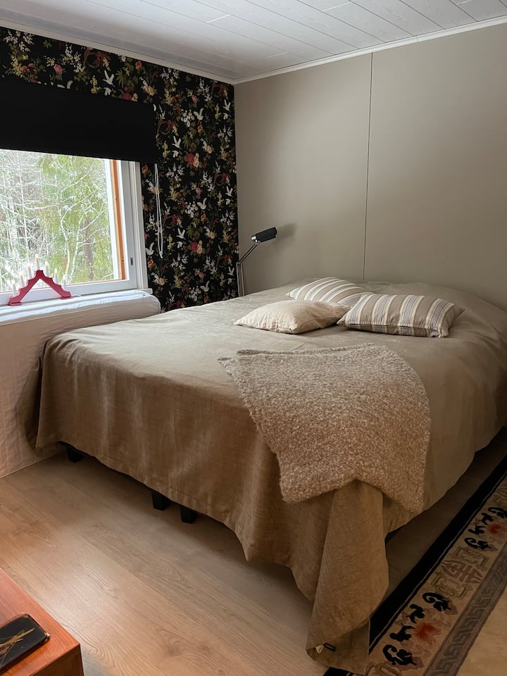 Това е двойното легло в основната къща. 
На прозореца има затъмняваща завеса. 