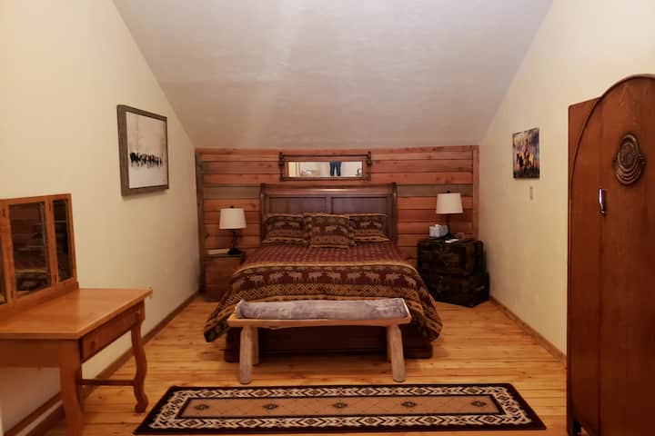 Master bedroom, with desk.  Has large area that will easily accommodate a queen size air mattress.
Nice rocker for relaxing with the forested view out the window.
Mini split for your heat and air conditioning comfort.