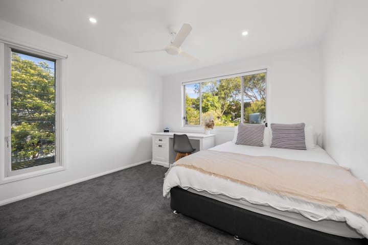 Second Bedroom upstairs with a queen bed, walk in wardrobe and study desk available. Ceiling fans are in each bedroom.