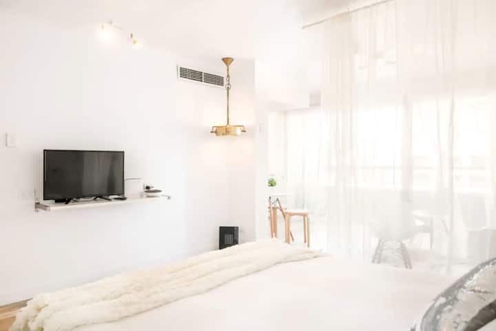 Watch TV after a long day at work from your queen bed.