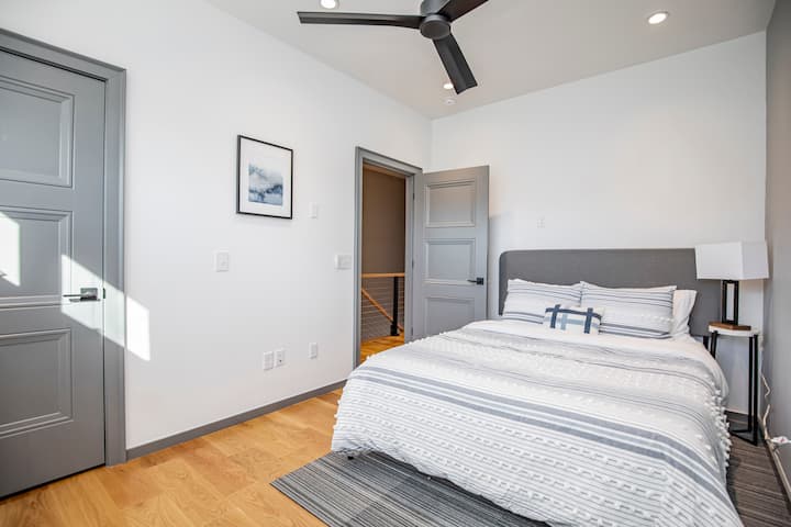 Queen bed in the second bedroom with nearby bathroom. 