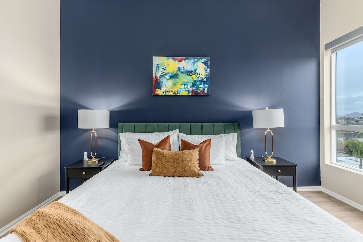 The attention to detail in our dapper bedroom is evident in every stylish element, from the plush throw pillows to the artfully arranged gallery wall.