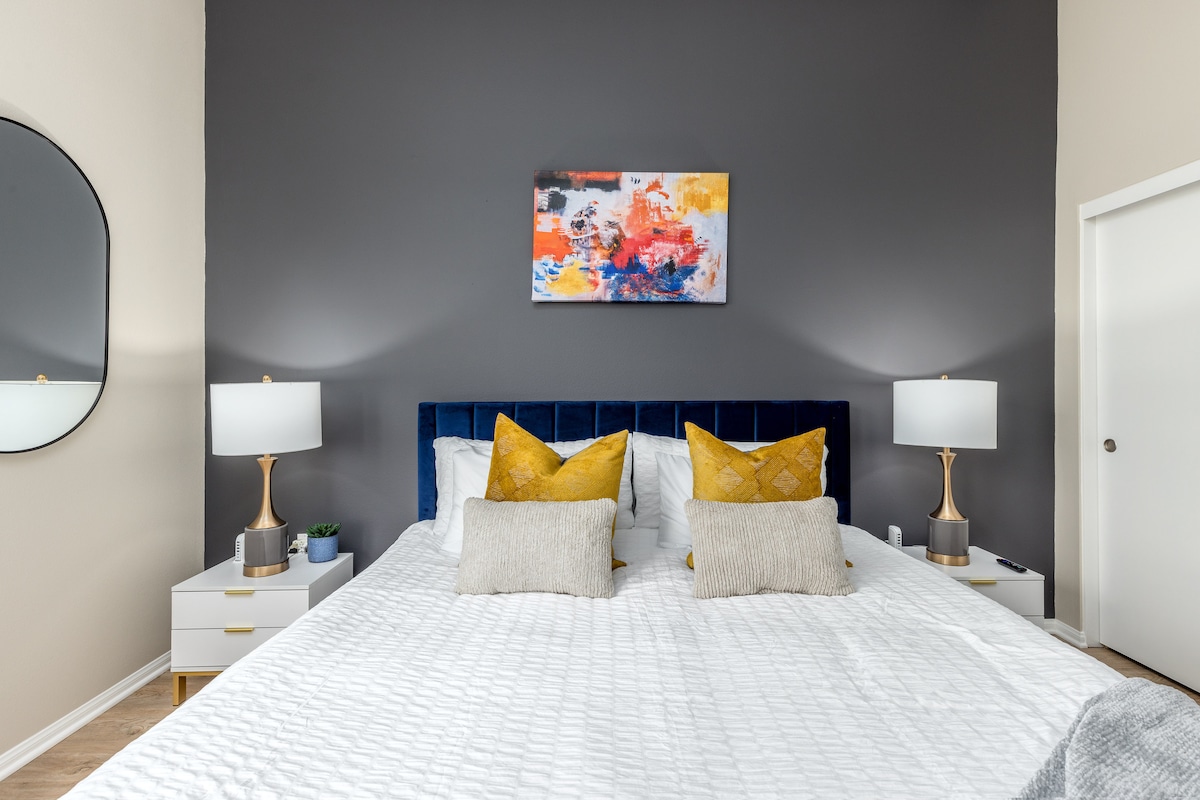 This beautifully designed bedroom is the perfect blend of art and comfort, with original artwork, artistic decor, and a flat-screen TV for ultimate relaxation.