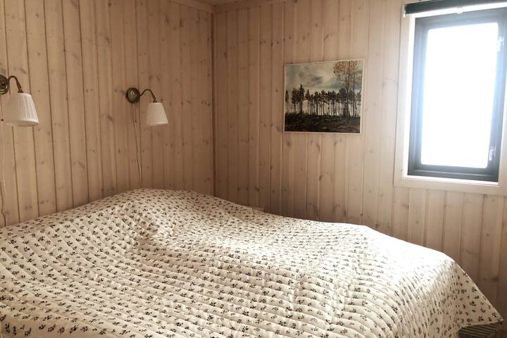 Bedroom with double bed and two bedside tables.