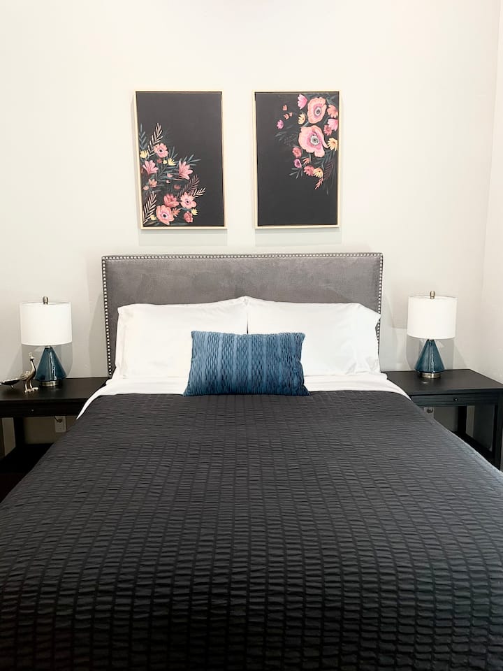 Second Bedroom: Queen Bed, closet storage, luggage rack & dresser.