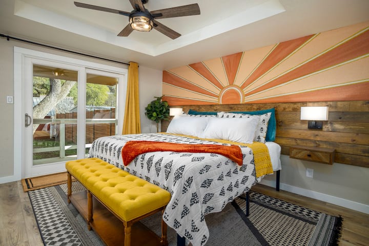MAIN HOUSE:  Bedroom 1-master bedroom- KING bed: We call it the Sunshine room.  Has glass sliding doors and a small patio right outside.  It also has a full bathroom connected to it.  We hope the custom accent wall gets you in the mood for summer.