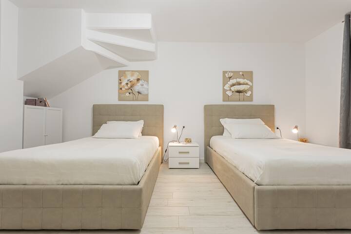 deuxième chambre avec 2 lits à la française à la place et demi chacun. vous pouvez utiliser les lits comme simples ou comme lits doubles à deux places chacun.