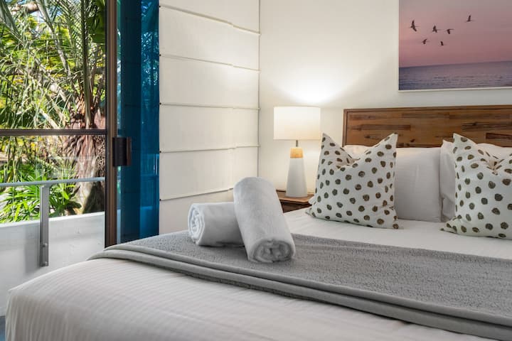 Master bedroom with TV, ensuite and private balcony.