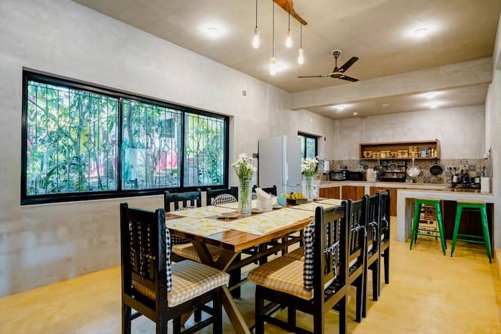 The 10-seater dining table adjoins the kitchen and forms the heart of the house.