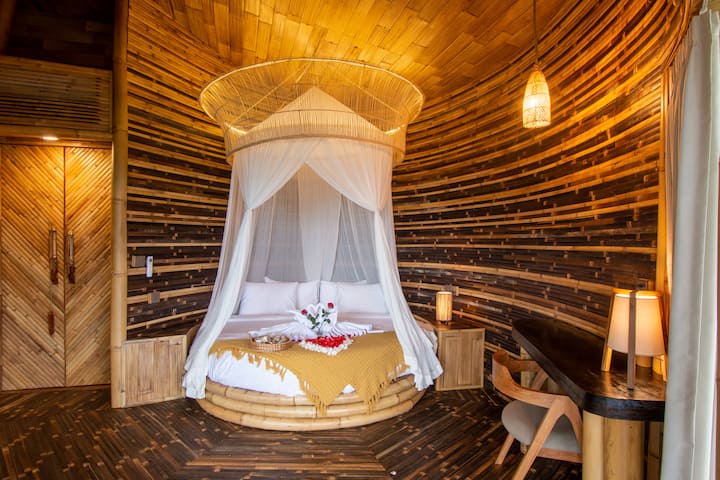 Middle Bedroom - Equipped with a round bed, desk, wardrobe, standing mirror and its own Balcony with Bathtub.