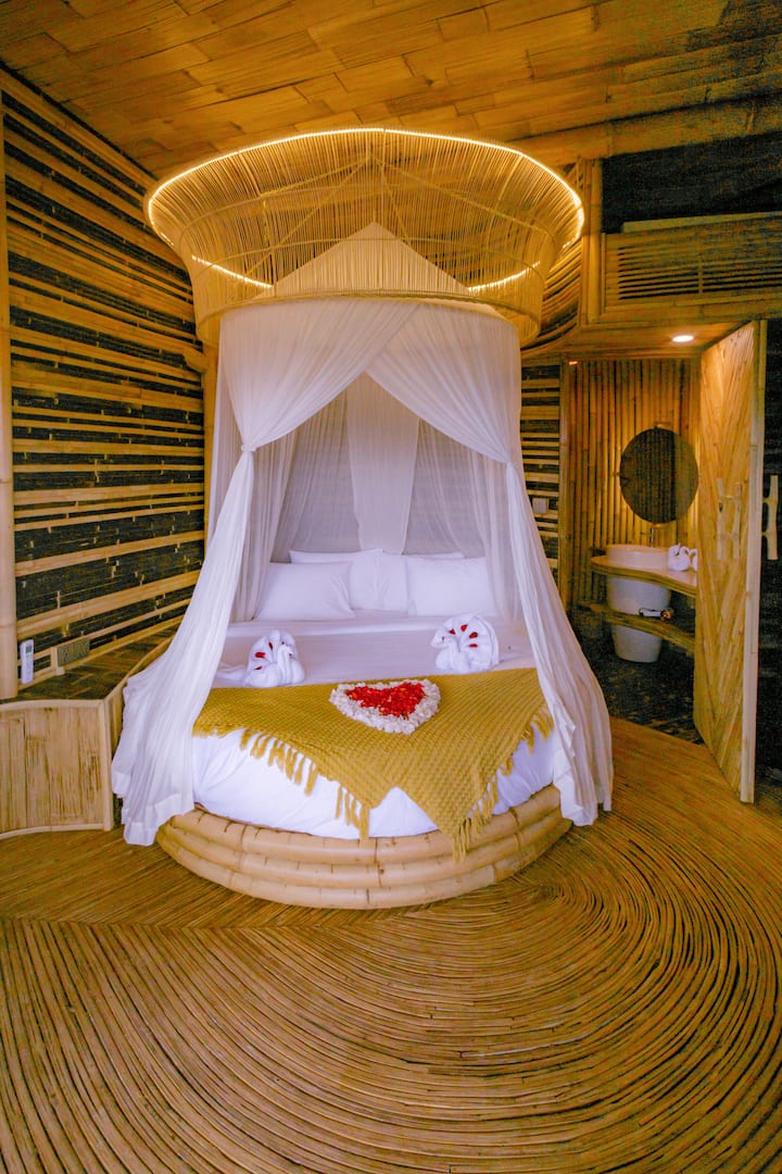 Lower Bedroom - Equipped with a round bed, desk, wardrobe, standing mirror and its own Balcony with Bathtub.