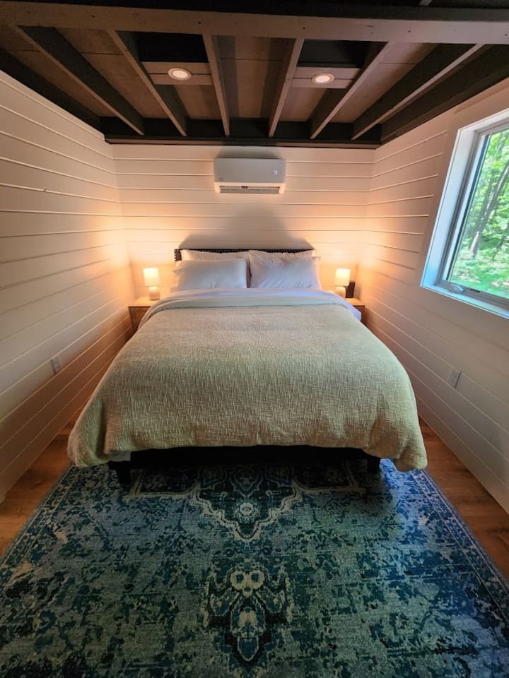 Queen bed with double duvets and 600 thread count sheets.  Behind each night stand are outlet extenders with multiple ports available for charging your devices.