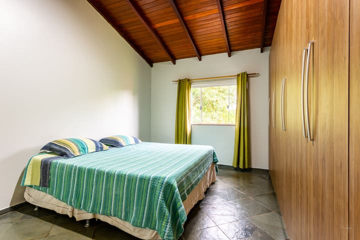 ROOM 5 - Queen bed on the 1st floor with side view of the villa.